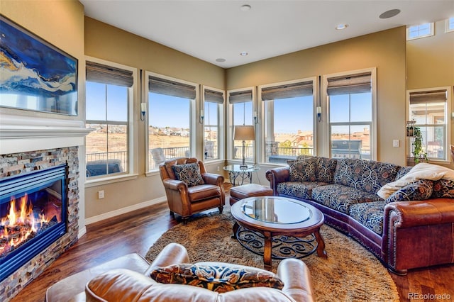 living room with a wealth of natural light and dark hardwood / wood-style flooring