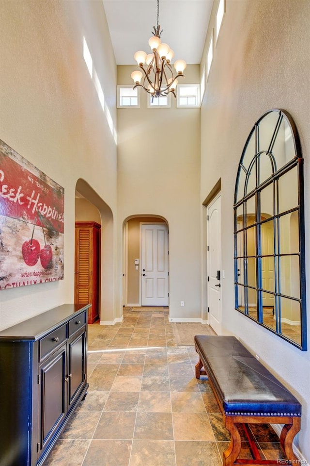 foyer with a high ceiling and an inviting chandelier