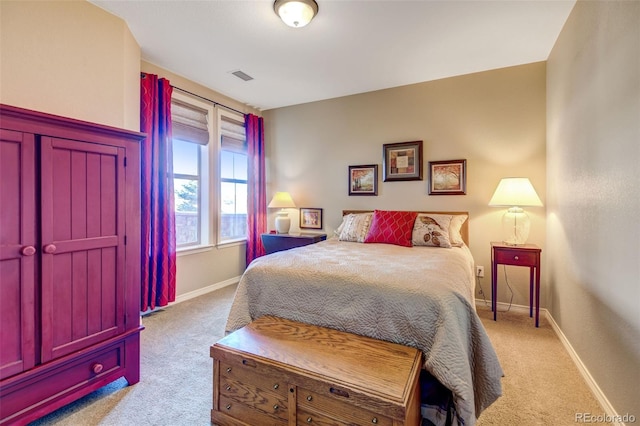 bedroom featuring light carpet