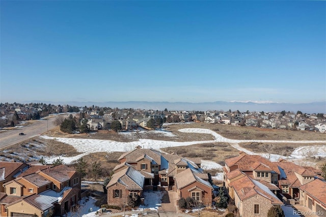 snowy aerial view with a residential view