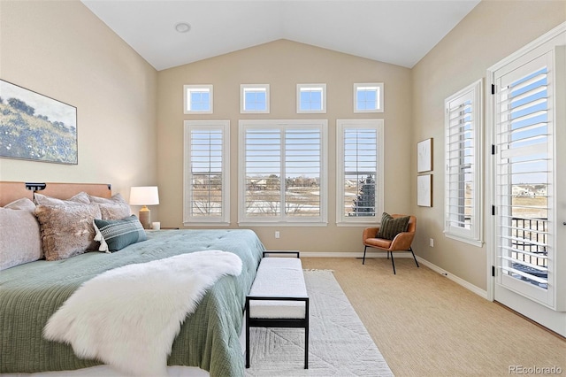 bedroom featuring multiple windows, light colored carpet, baseboards, and lofted ceiling