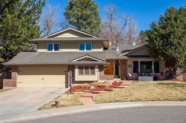 split level home featuring a shingled roof, concrete driveway, brick siding, and a front lawn