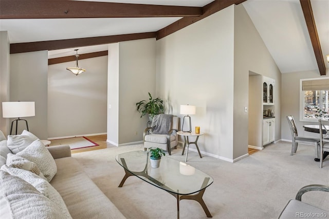 living room featuring light carpet, lofted ceiling with beams, and baseboards