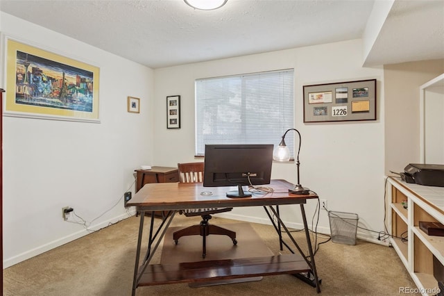 home office with baseboards, light carpet, and a textured ceiling