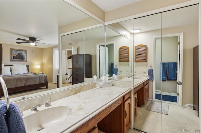 bathroom featuring baseboards, ensuite bath, vanity, and a ceiling fan