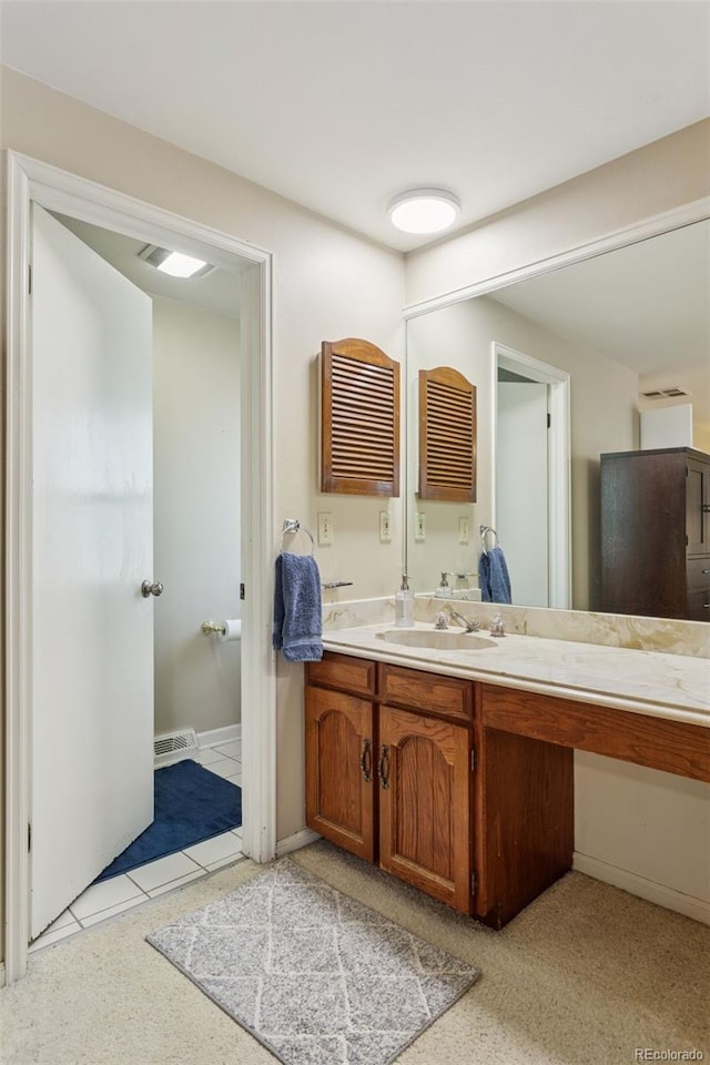 bathroom with visible vents, baseboards, and vanity