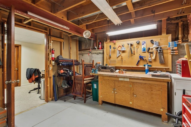 unfinished below grade area featuring a workshop area