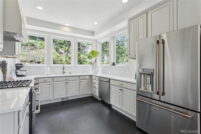 4978 Camel Heights Rd, Evergreen, CO 80439 - kitchen featuring high quality appliances, extractor fan, dark tile patterned floors, healthy amount of natural light, and recessed lighting