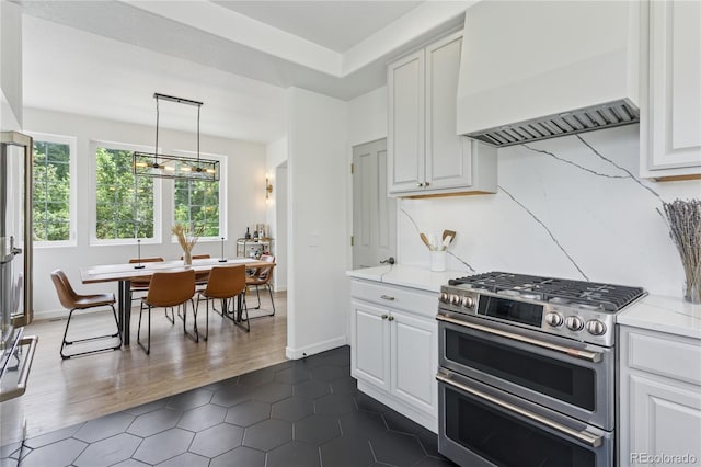 4978 Camel Heights Rd, Evergreen, CO 80439 - kitchen featuring range with two ovens, custom range hood, white cabinetry, and dark tile patterned floors