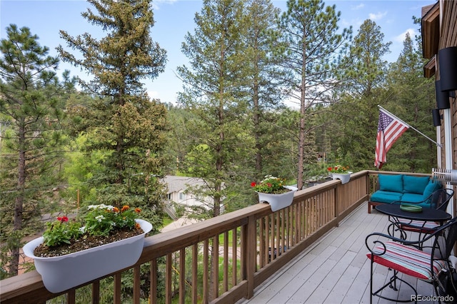 4978 Camel Heights Rd, Evergreen, CO 80439 - wooden deck with a wooded view