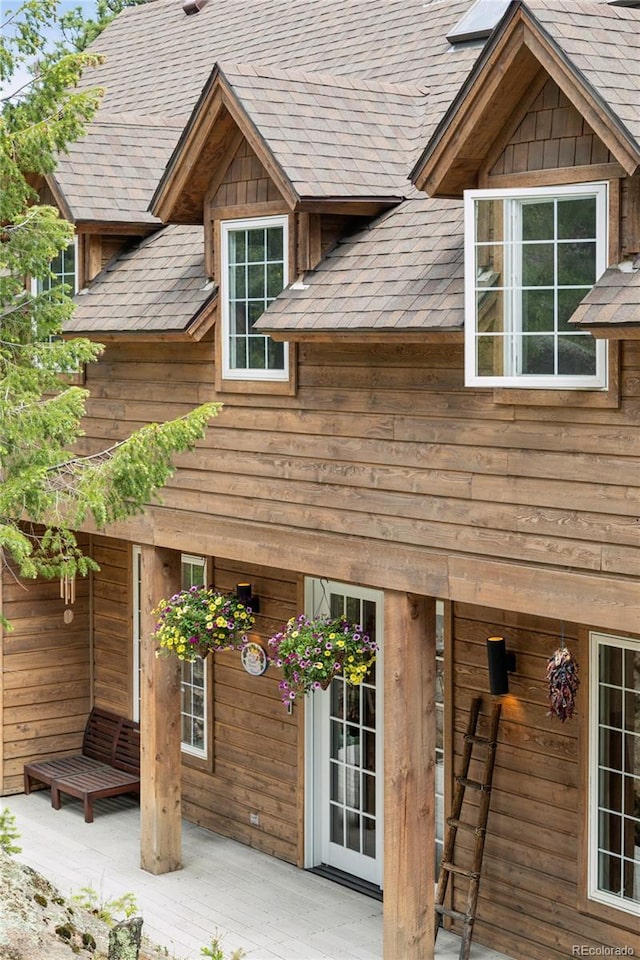 4978 Camel Heights Rd, Evergreen, CO 80439 - back of property with a shingled roof and a patio