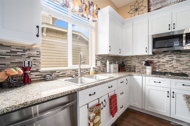 2726 Aylesbury Way, Johnstown, CO 80534 - kitchen with stainless steel appliances, a sink, white cabinetry, and tasteful backsplash