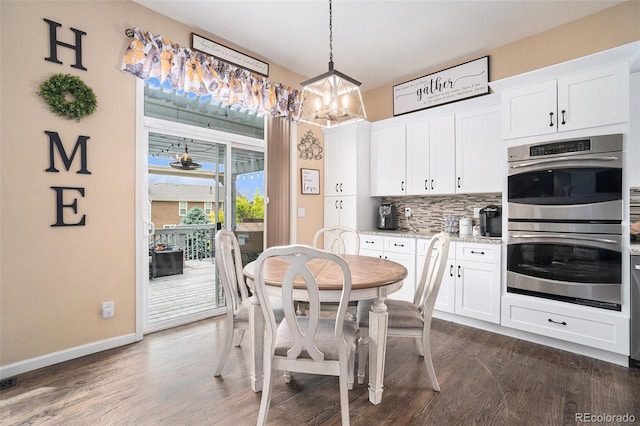 2726 Aylesbury Way, Johnstown, CO 80534 - dining area with a chandelier, dark wood-type flooring, and baseboards