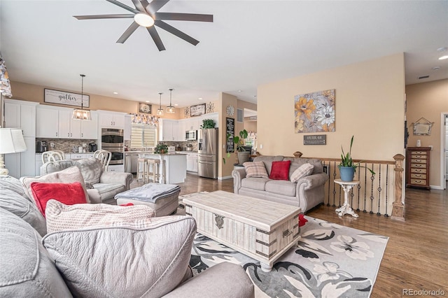 2726 Aylesbury Way, Johnstown, CO 80534 - living room with ceiling fan, dark wood-style flooring, recessed lighting, and baseboards