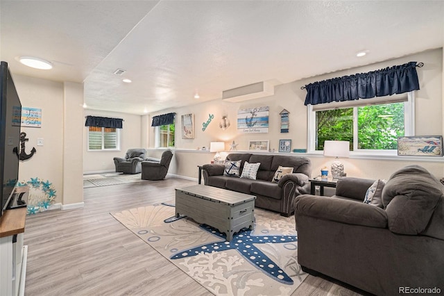 2726 Aylesbury Way, Johnstown, CO 80534 - living area featuring healthy amount of natural light, wood finished floors, baseboards, and recessed lighting