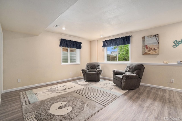 2726 Aylesbury Way, Johnstown, CO 80534 - living area featuring wood finished floors, baseboards, and recessed lighting
