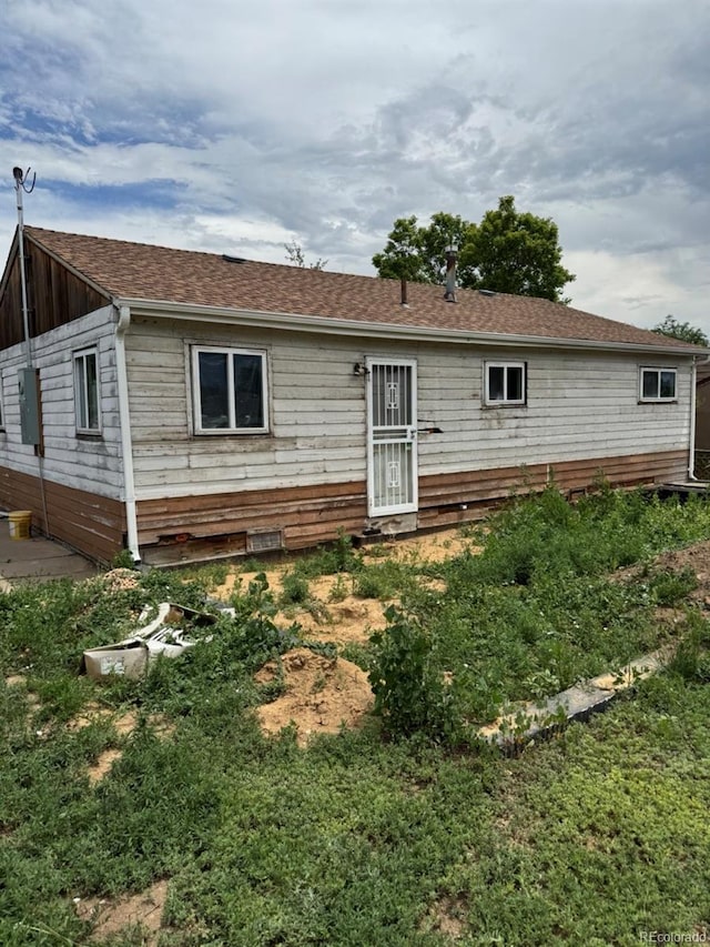 1105 S Raleigh St, Denver, CO 80219 - rear view of house featuring a shingled roof