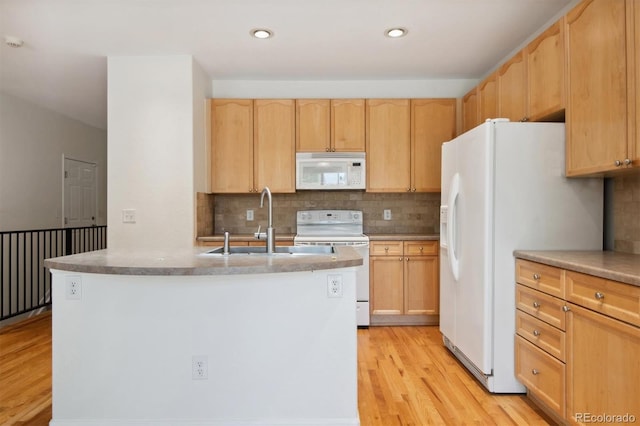 kitchen featuring light hardwood / wood-style flooring, white appliances, sink, light brown cabinets, and decorative backsplash