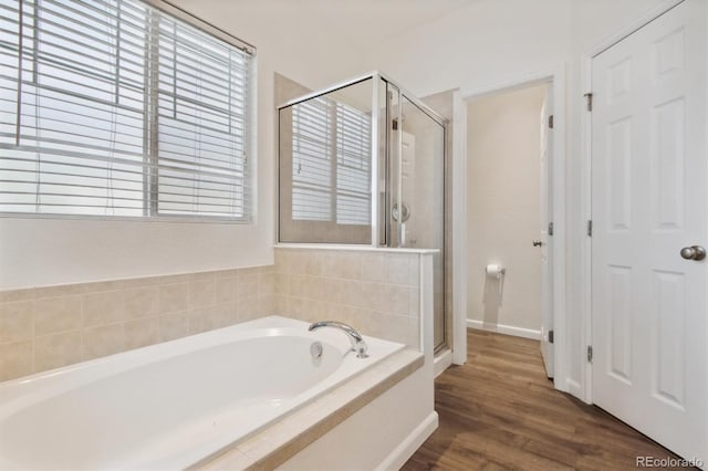 bathroom featuring hardwood / wood-style flooring and independent shower and bath