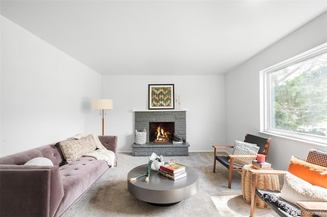 living area featuring carpet flooring and a fireplace