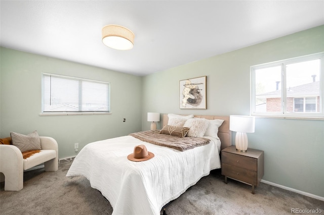 bedroom with multiple windows, carpet, and baseboards