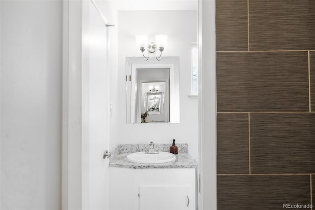 bathroom featuring a chandelier and vanity