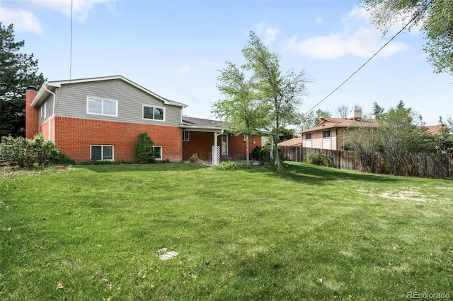 rear view of property with brick siding and a chimney