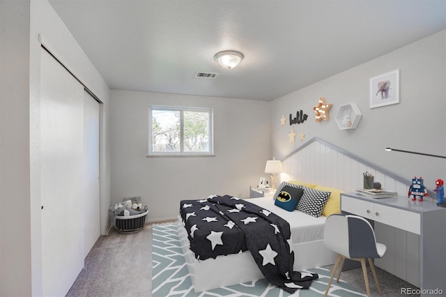 carpeted bedroom featuring a closet