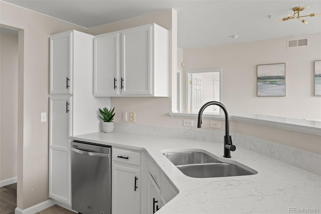7440 S Blackhawk St Unit 2-108, Englewood, CO 80112 - kitchen with stainless steel dishwasher, light stone counters, and white cabinetry