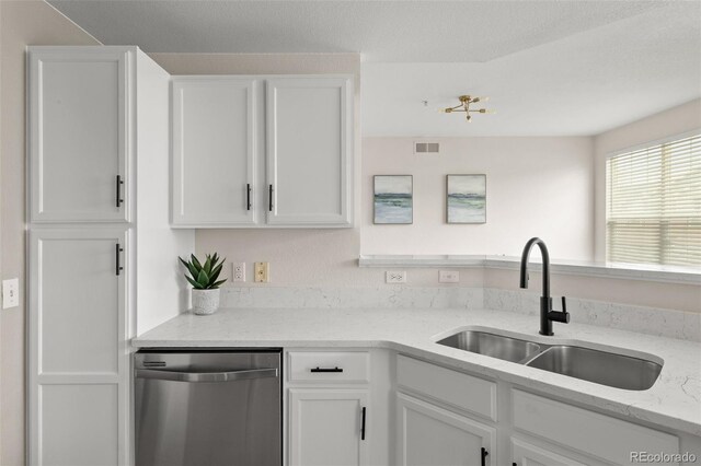 7440 S Blackhawk St Unit 2-108, Englewood, CO 80112 - kitchen with dishwasher, white cabinets, and light stone countertops