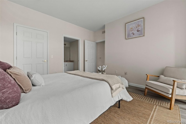 7440 S Blackhawk St Unit 2-108, Englewood, CO 80112 - bedroom with wood finished floors and baseboards