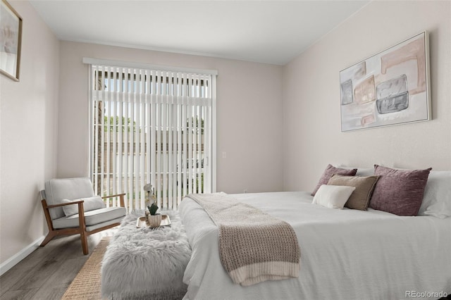 7440 S Blackhawk St Unit 2-108, Englewood, CO 80112 - bedroom featuring wood finished floors and access to outside