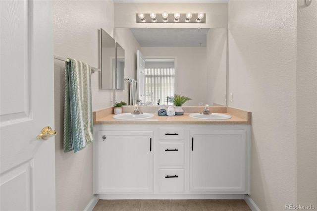 7440 S Blackhawk St Unit 2-108, Englewood, CO 80112 - bathroom with double vanity and baseboards