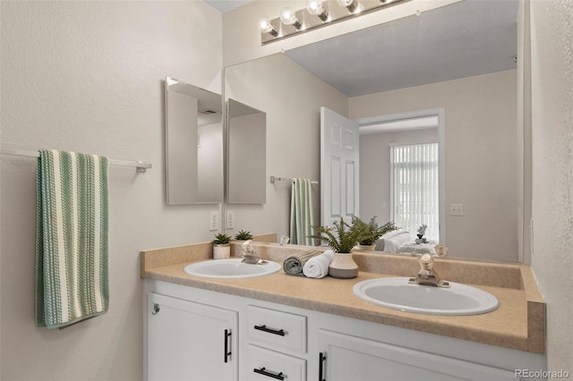 7440 S Blackhawk St Unit 2-108, Englewood, CO 80112 - bathroom with double vanity and a textured wall