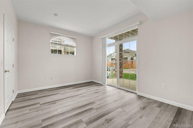 7440 S Blackhawk St Unit 2-108, Englewood, CO 80112 - unfurnished bedroom featuring access to outside and wood finished floors