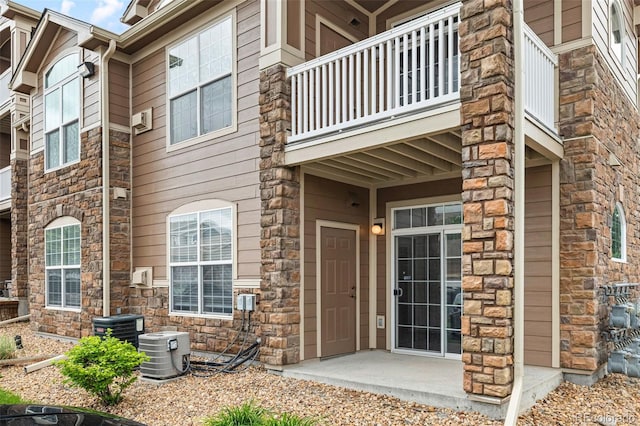 7440 S Blackhawk St Unit 2-108, Englewood, CO 80112 - entrance to property with a balcony and stone siding