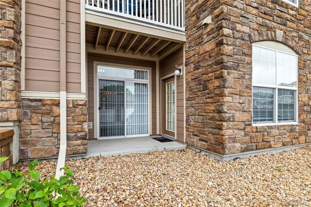 7440 S Blackhawk St Unit 2-108, Englewood, CO 80112 - entrance to property with stone siding and a balcony
