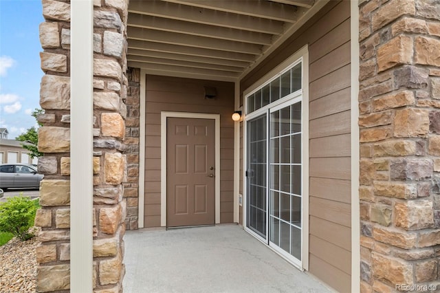 7440 S Blackhawk St Unit 2-108, Englewood, CO 80112 - doorway to property featuring stone siding