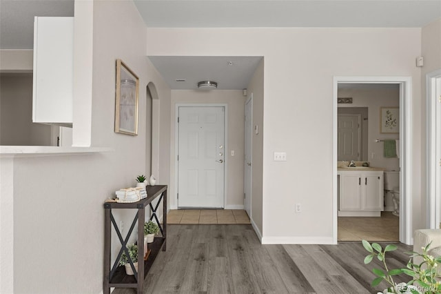 7440 S Blackhawk St Unit 2-108, Englewood, CO 80112 - entryway with light wood finished floors and arched walkways