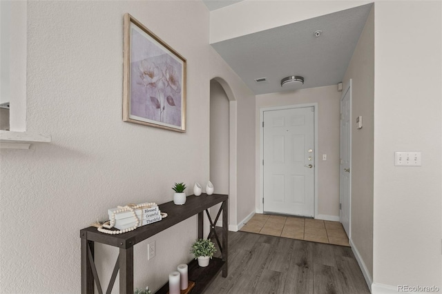 7440 S Blackhawk St Unit 2-108, Englewood, CO 80112 - doorway with arched walkways and wood finished floors