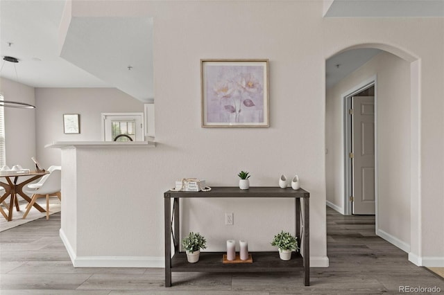 7440 S Blackhawk St Unit 2-108, Englewood, CO 80112 - hallway featuring wood finished floors and arched walkways