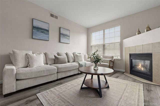7440 S Blackhawk St Unit 2-108, Englewood, CO 80112 - living room with wood finished floors and a tile fireplace