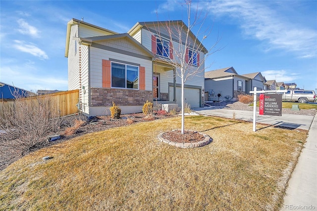 view of front of property featuring a front lawn and a garage