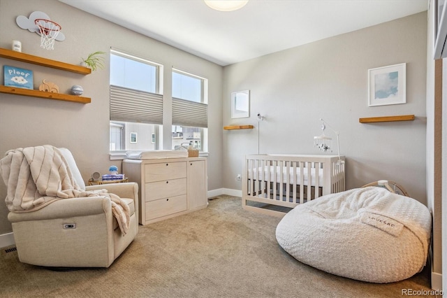 bedroom with a crib and light colored carpet