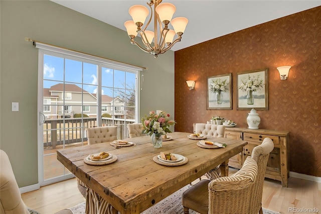 dining room with a chandelier and light hardwood / wood-style floors