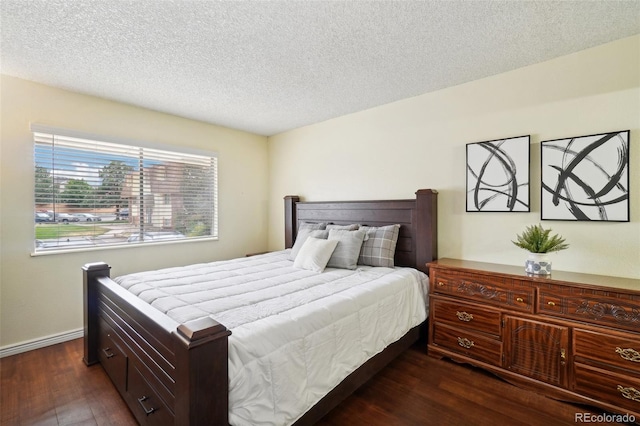 bedroom with dark wood-type flooring and a textured ceiling