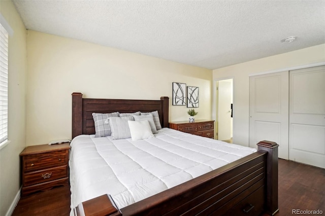 bedroom with dark hardwood / wood-style flooring, a closet, and a textured ceiling