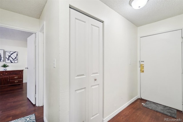 foyer entrance featuring dark hardwood / wood-style floors and a textured ceiling