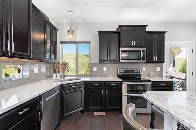 2999 Merry Rest Way, Castle Rock, CO 80109 - kitchen featuring stainless steel appliances, healthy amount of natural light, dark wood finished floors, and pendant lighting