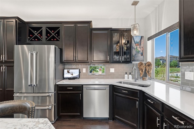 2999 Merry Rest Way, Castle Rock, CO 80109 - kitchen featuring appliances with stainless steel finishes, decorative backsplash, light countertops, and dark wood-style floors